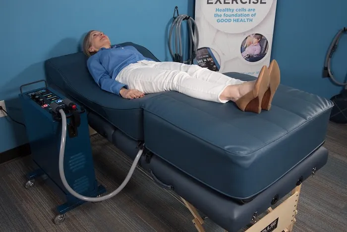 Woman lays on a PEMF total body contour bed