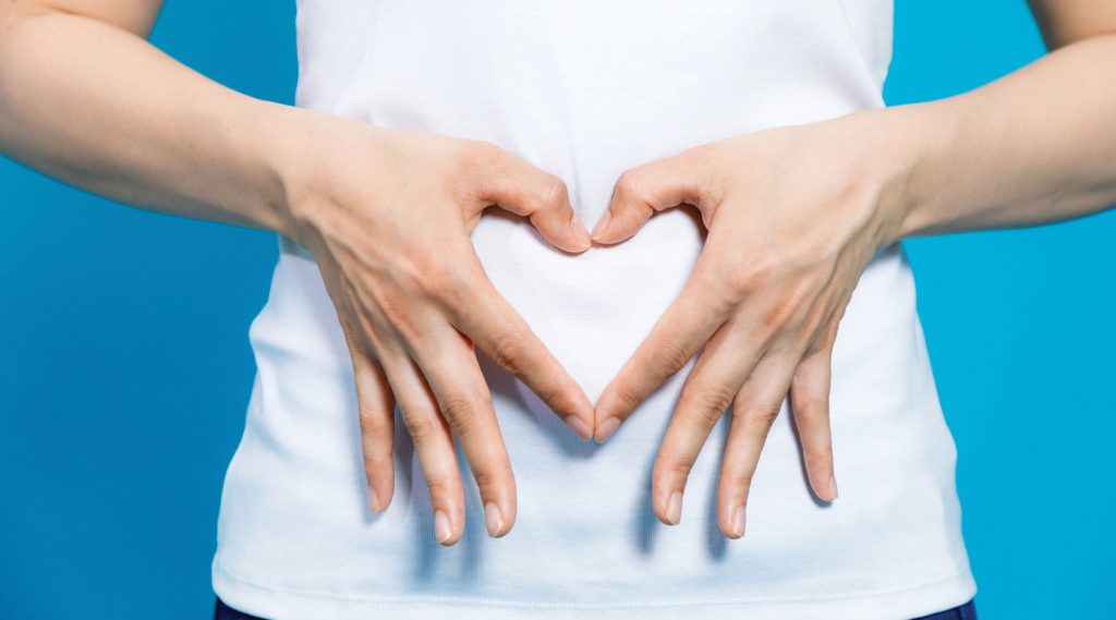 Hands of a lady shaping a heart.