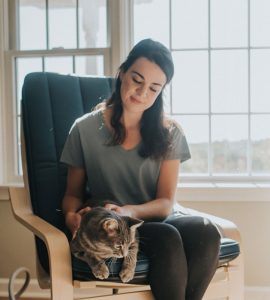 An image of a woman and her cat sitting in a Chair Pad With Chair