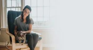 An image of a woman and her cat sitting in a Chair Pad With Chair