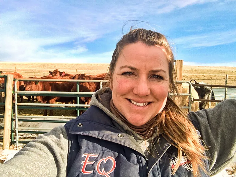 We Love Pulse PEMF: Running An Animal Wellness Business An image of Kirstie Wachholtz with cows in the background