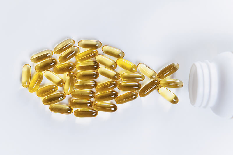 Fish oil capsules and a bottle of fish oil, a natural source of omega-3 fatty acids for a healthy lifestyle.