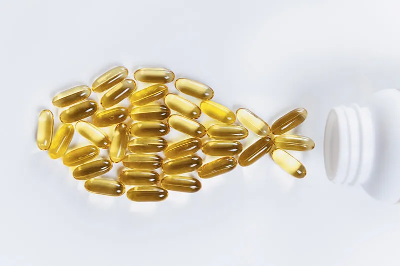 Fish oil capsules and a bottle of fish oil, a natural source of omega-3 fatty acids for a healthy lifestyle.