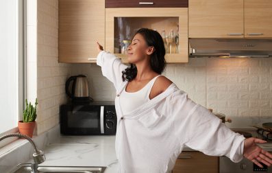 A girl in a white shirt with arms wide open